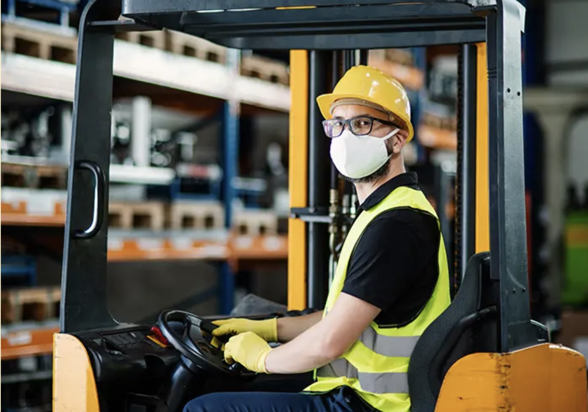 Worker Using Forklift in Warehouse